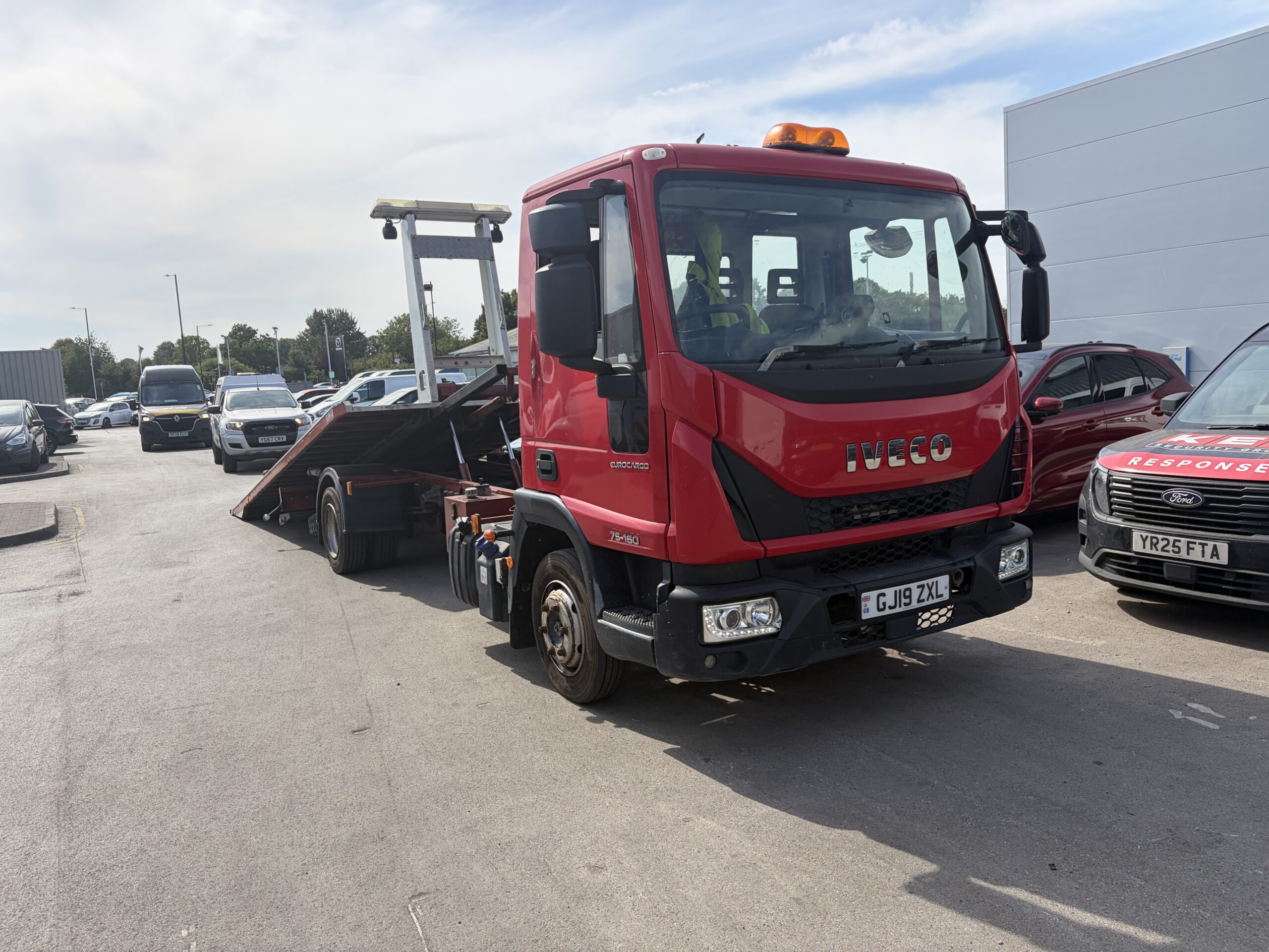 Iveco Eurocargo slide-bed lowered for loading