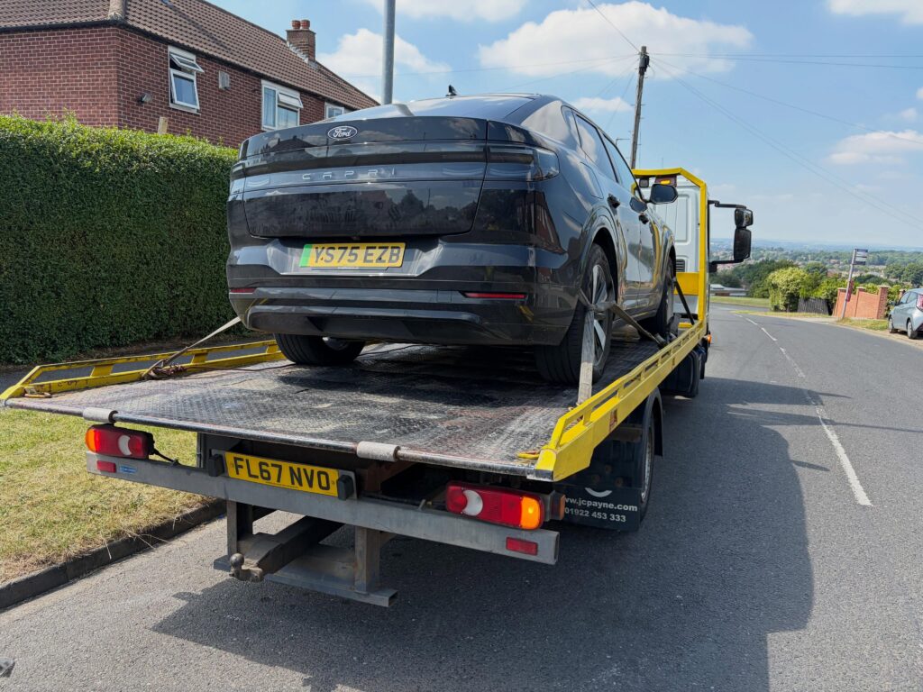 Black Ford Capri on a recovery slidebed